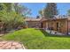 This home features a spacious backyard, a well-manicured lawn, and a fun play area, ideal for Gathering enjoyment at 1235 Dahlia St, Denver, CO 80220
