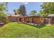 Expansive backyard featuring a well-maintained lawn and charming patio, perfect for outdoor entertaining and relaxation at 1235 Dahlia St, Denver, CO 80220