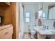 Bathroom with pedestal sink, toilet, and combination shower-bath at 1235 Dahlia St, Denver, CO 80220