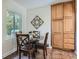 Eat-in kitchen area with four chairs, a table, and extra pantry storage at 1235 Dahlia St, Denver, CO 80220