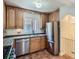 Functional kitchen featuring ample cabinetry, stainless steel appliances, and tiled flooring, ready for cooking at 1235 Dahlia St, Denver, CO 80220