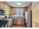 Well-lit kitchen with stainless steel appliances and light wood cabinets at 1235 Dahlia St, Denver, CO 80220