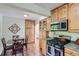 Well-organized kitchen with a dining area, stainless steel appliances, and plenty of cabinet storage at 1235 Dahlia St, Denver, CO 80220