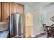Practical kitchen design featuring stainless steel refrigerator, ample cabinets, and a view to the dining area at 1235 Dahlia St, Denver, CO 80220