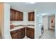Convenient laundry room with wooden cabinets, backsplash, and modern washer and dryer at 1235 Dahlia St, Denver, CO 80220