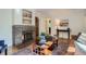 Warm living room with a brick fireplace, hardwood floors, elegant furniture, and tasteful decor at 1235 Dahlia St, Denver, CO 80220