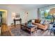 Bright living room with a cozy sofa, hardwood floors, an antique table, and natural light at 1235 Dahlia St, Denver, CO 80220