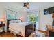 Bright main bedroom with large windows, hardwood flooring, and ceiling fan at 1235 Dahlia St, Denver, CO 80220