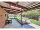 Covered patio with skylight, seating, and a well-manicured lawn, offers the perfect space for relaxation and outdoor gatherings at 1235 Dahlia St, Denver, CO 80220