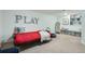Cozy playroom includes 'PLAY' decor, a dollhouse, and integrated toy storage at 1235 Dahlia St, Denver, CO 80220