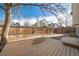 Spacious backyard featuring a wood deck, brick patio, and a tall privacy fence at 12977 W Dorado Pl, Littleton, CO 80127