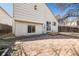 Backyard view with a brick patio, deck, and sliding glass door entrance to the home at 12977 W Dorado Pl, Littleton, CO 80127