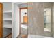 Bathroom featuring tile accents, built in shelving, and a view into a carpeted bedroom at 12977 W Dorado Pl, Littleton, CO 80127