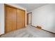 Bedroom showcasing a closet with sliding doors, neutral carpet, and white walls at 12977 W Dorado Pl, Littleton, CO 80127