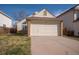 Charming home featuring an attached two car garage and large front lawn at 12977 W Dorado Pl, Littleton, CO 80127