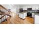Open kitchen featuring an island, stainless steel appliances and hardwood floors at 12977 W Dorado Pl, Littleton, CO 80127