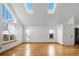 Bright living room featuring hardwood floors, skylights, and multiple windows at 12977 W Dorado Pl, Littleton, CO 80127