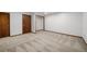 Open living room featuring neutral carpet and a closet with shelving at 12977 W Dorado Pl, Littleton, CO 80127