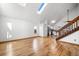 Bright living room featuring hardwood floors, skylights, and an open staircase at 12977 W Dorado Pl, Littleton, CO 80127