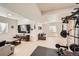 Spacious basement featuring light wood flooring, neutral walls, and workout and living area at 1994 Spencer Ave, Castle Rock, CO 80104