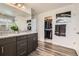 Bathroom featuring a granite countertop vanity, a walk-in closet, and modern fixtures at 1994 Spencer Ave, Castle Rock, CO 80104