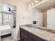 Granite-top bathroom with vanity, large mirror and a view into an adjacent bedroom at 1994 Spencer Ave, Castle Rock, CO 80104