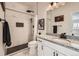 Modern bathroom featuring white marble tiling, black hardware, and a granite countertop vanity at 1994 Spencer Ave, Castle Rock, CO 80104