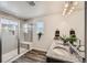 Bright bathroom with a glass-enclosed shower, a double sink vanity, and ample natural light at 1994 Spencer Ave, Castle Rock, CO 80104