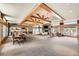 A view of the clubhouse including a sitting area, fireplace, and kitchen space at 1994 Spencer Ave, Castle Rock, CO 80104