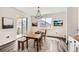 Bright dining room with natural light, modern light fixture, and sliding door access to the backyard at 1994 Spencer Ave, Castle Rock, CO 80104