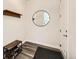 Bright entryway featuring wood-look flooring, a round mirror, and a wooden shoe rack at 1994 Spencer Ave, Castle Rock, CO 80104