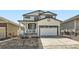 Charming two-story home featuring a two-car garage and a welcoming front porch with white trim at 1994 Spencer Ave, Castle Rock, CO 80104