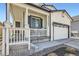 Charming home featuring a covered porch, white brick accents, and a two-car garage at 1994 Spencer Ave, Castle Rock, CO 80104