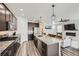 Modern kitchen with stainless steel appliances, granite countertops, and an island with bar seating at 1994 Spencer Ave, Castle Rock, CO 80104