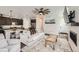 Open concept living area featuring a fireplace, wood floors, and seamless access to the kitchen at 1994 Spencer Ave, Castle Rock, CO 80104