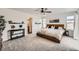 Well-lit main bedroom featuring a wooden bed frame and a decorative shelf with plants for added charm at 1994 Spencer Ave, Castle Rock, CO 80104