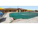 Community pool with cover with clubhouse in the background, creating a beautiful recreational space at 1994 Spencer Ave, Castle Rock, CO 80104