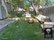 Cozy backyard featuring outdoor sofa, two chairs, and a wood-burning fire pit on a green lawn at 5612 S Lansing Ct, Englewood, CO 80111