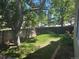 Grassy backyard with wood fence, big tree, and brick border at 5612 S Lansing Ct, Englewood, CO 80111