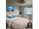 Bright bedroom with a large bed, blue accents, a window with natural light, and modern lighting fixture at 5612 S Lansing Ct, Englewood, CO 80111
