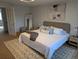 Spacious bedroom with large bed, stylish rug, and accent wall art, creating a peaceful retreat at 5612 S Lansing Ct, Englewood, CO 80111