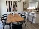 Modern dining room featuring sleek table, barstool seating and an adjacent kitchen area at 5612 S Lansing Ct, Englewood, CO 80111