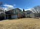 Traditional home featuring an attached two-car garage and professionally landscaped front yard at 5612 S Lansing Ct, Englewood, CO 80111