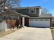 Charming two-story home with a two car garage, brick accents, and a well-maintained front yard at 5612 S Lansing Ct, Englewood, CO 80111