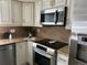 Bright kitchen with granite countertops, stainless steel appliances, and modern finishes at 5612 S Lansing Ct, Englewood, CO 80111
