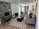 Open-concept living room with modern fireplace, stylish decor, and seamless access to the dining area at 5612 S Lansing Ct, Englewood, CO 80111