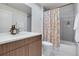 Modern bathroom with a colorful shower curtain, vanity, and patterned tile floor at 1921 Hooker St, Denver, CO 80204