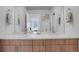 Modern bathroom featuring double sinks, wood cabinets, and a large mirror at 1921 Hooker St, Denver, CO 80204