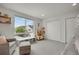 Bright bedroom featuring a large window, gray carpet, and a cozy sitting area at 1921 Hooker St, Denver, CO 80204