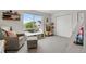 Bright bedroom featuring a large window, gray carpet, and a cozy sitting area at 1921 Hooker St, Denver, CO 80204